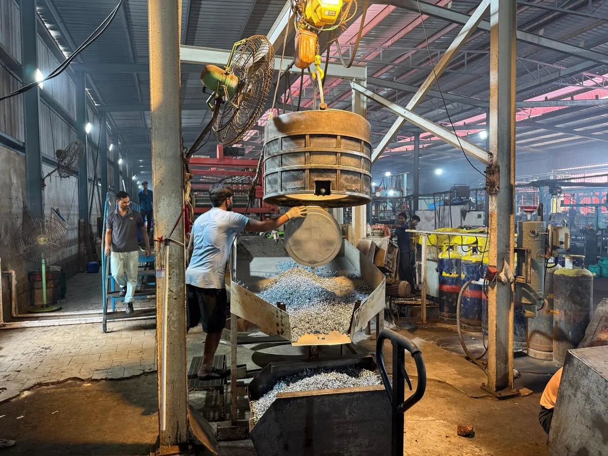 Workers loading finished fasteners at the Landmark Crafts production unit